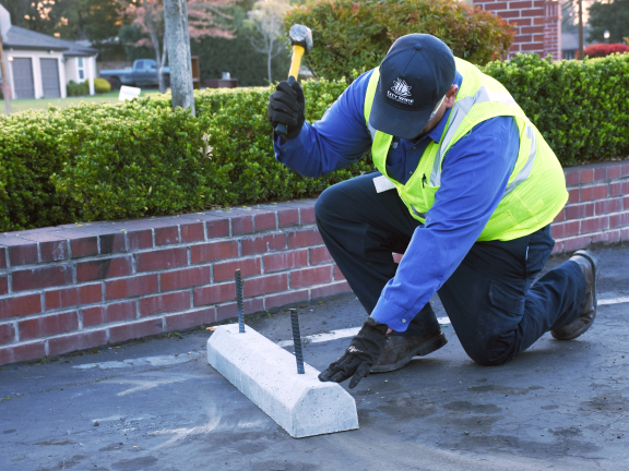 Close-up of technician working on parking lot 